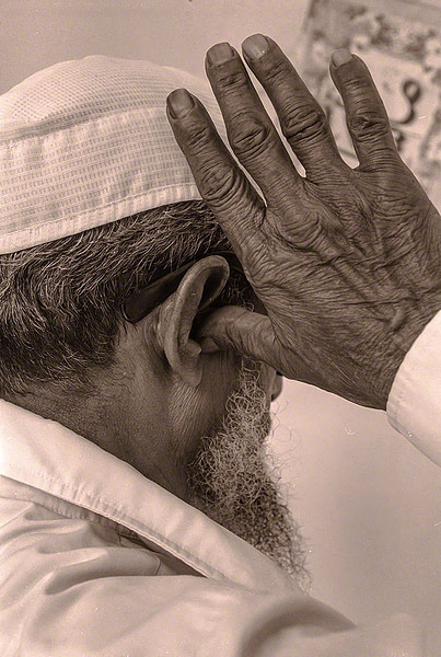 The muazzin recites the Adhan at Jumma Masjid 1976 h3-11-40