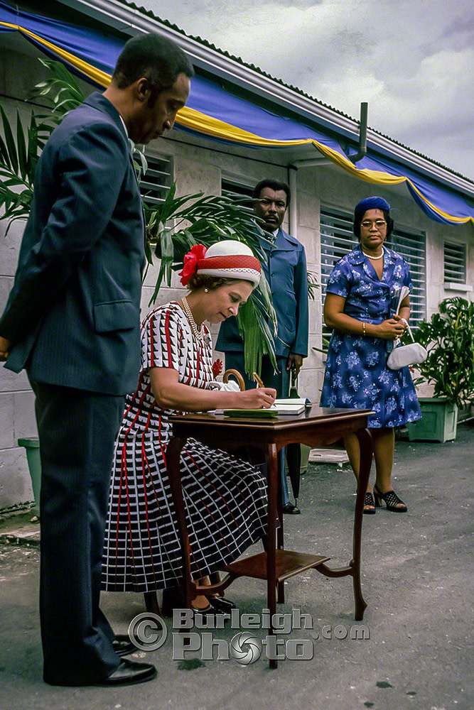 Queen Elizabeth signs the guest book at the John Beckles Day Nursery, Silver Jubilee, Barbados 1977